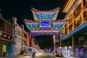 a lit up chinese sign on a street at night at Yunqi Selected Hotel in Xi'an