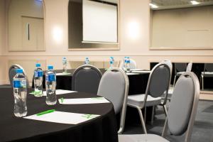 a dining room table with chairs and tables at Holiday Inn Werribee, an IHG Hotel in Werribee