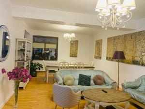 a living room with a couch and a table at DATIVO HOUSE in Mamaia Sat/Năvodari