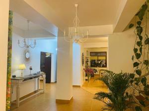 a kitchen and a living room with a chandelier at DATIVO HOUSE in Mamaia Sat/Năvodari
