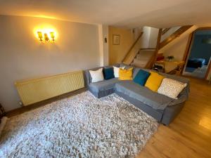 a living room with a couch and a rug at Pet Friendly Dairy Cottage in Solihull