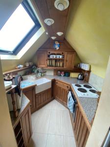 a kitchen with a sink and a stove top oven at Pet Friendly Dairy Cottage in Solihull