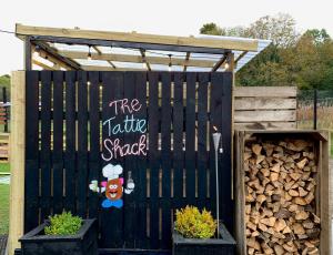 a black fence with a sign that says the knife shack at Allangrange Hotel near Inverness in Munlochy