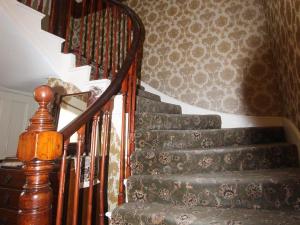 a stairway with a wooden railing and a stair case at Spring Garden Guest House in Gosport