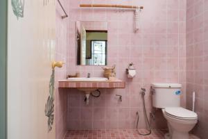 a pink bathroom with a sink and a toilet at Tropical Home Koh Phangan in Thongsala +70 photos