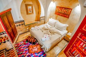 a bedroom with a bed and a mirror at Riad Chorfa in Marrakesh +37 photos