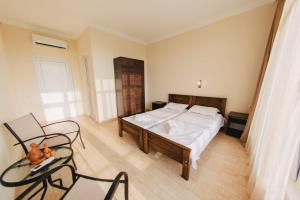 a bedroom with a bed and a table and chairs at sea-horizon in K'obulet'i