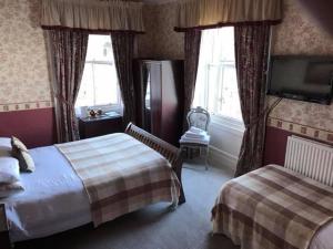 A bed or beds in a room at The Stag Head Hotel