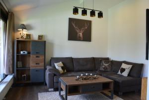 a living room with a couch and a coffee table at Ferienhaus Starenweg 6 in Eichbach