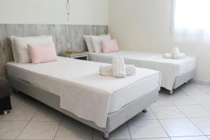 Postel nebo postele na pokoji v ubytování Iason Apartments