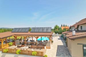 an outdoor patio with solar panels on a building at 16 Lakes Hotel in Grabovac