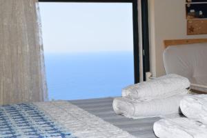 A bed or beds in a room at Villa Thetis with private pool where the sunsets fade away