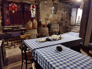 a room with a table with a blue and white checkered table cloth at Konak -Guest house -Ramonda Serbika in Niš
