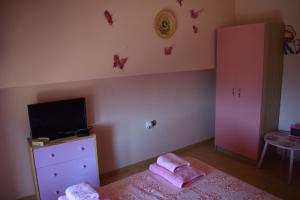 A television and/or entertainment centre at Villa Thetis with private pool where the sunsets fade away