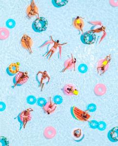 a group of people in the water at a swimming pool at Nikki Beach Resort & Spa in Porto Heli