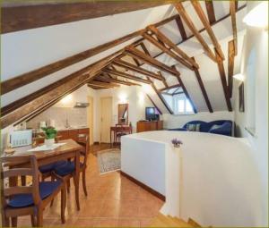 a living room with a table and a dining room at Apartments Vi-La in Dubrovnik