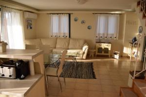 A seating area at Villa Thetis with private pool where the sunsets fade away