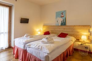 A bed or beds in a room at Aparthotel Claviere