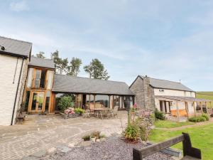 an external view of a house with a patio at Pant Dafydd Goch in Glyn-Ceiriog