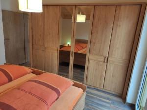 a bedroom with two beds and a mirror at Ferienwohnungen Graßmann in Piding
