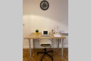 an office desk with a laptop and a chair at The Onyx Suite - 1 Bed apartment w/ free parking in Cardiff