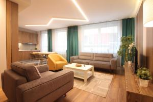 a living room with a couch and a table at Sarajevo Daily Apartments in Sarajevo
