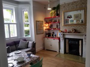 a living room with a table and a fireplace at Acara House B&B in Dublin