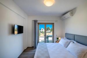 Postel nebo postele na pokoji v ubytování Villa Persephone + 25 fotografií