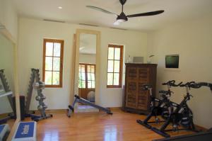 a gym with treadmills and exercise bikes in a room at Qambani Luxury Resort in Michamvi