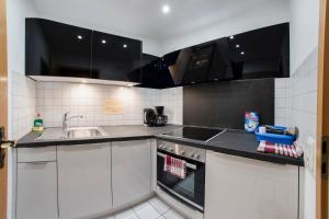 a kitchen with white cabinets and a sink at Hotel San Marco in Füssen