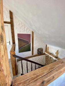 a staircase in a house with a picture on the wall at Maisonette Eifel, mit Sauna und Whirlpool in Dahlem
