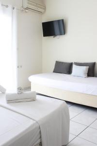 Postel nebo postele na pokoji v ubytování Iason Apartments