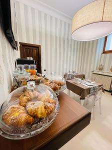 a table with several trays of pastries on it at L’Arco Bed&Breakfast in Avigliano