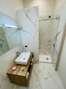 a bathroom with a sink and a shower at L’Arco Bed&Breakfast in Avigliano +17 photos