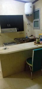 a kitchen with a counter and a sink and a chair at Amazing Chalet North Coast Egypt in Dawwār ‘Abd Allāh +22 photos