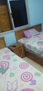 a bedroom with two beds and a window at Amazing Chalet North Coast Egypt in Dawwār ‘Abd Allāh