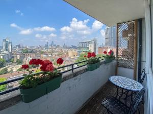 a balcony with flowers and a bench and a view at Pass the Keys Spacious 2Bedroom flat with views in London Bridge in London