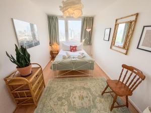 a bedroom with a bed and a chair and a window at Pass the Keys Spacious 2Bedroom flat with views in London Bridge in London