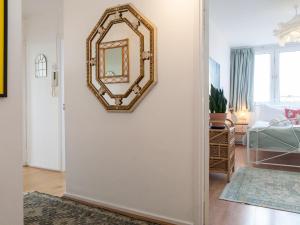 a mirror hanging on a wall in a living room at Pass the Keys Spacious 2Bedroom flat with views in London Bridge in London