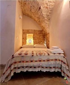 En eller flere senge i et værelse på La Casetta di Greta