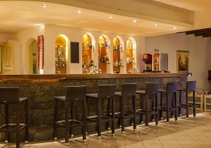 a row of stools at a bar in a restaurant at Elpida Village in Istro