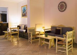 a living room with a couch and tables and a clock at Elpida Village in Istro