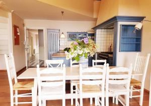 a dining room with a table with a vase of flowers at Vidaa Lago in Bleiswijk