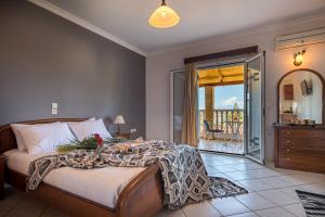 a bedroom with a bed and a balcony at Dinos Hotel in Tsilivi