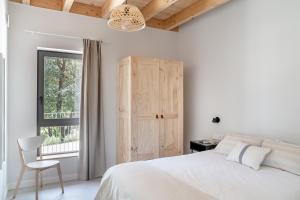 Ένα ή περισσότερα κρεβάτια σε δωμάτιο στο BAO 1 / APARTAMENTO CON JARDÍN