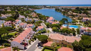 an aerial view of a town with a river and houses at 3 Bed Holiday Home Lakeside Village Quinta Do Lago in Faro