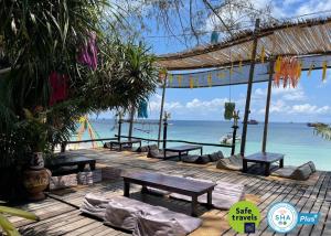 a wooden deck with benches and the ocean at AC 2 Resort in Koh Tao