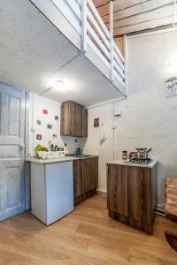 a kitchen with wooden cabinets and a white refrigerator at Апарт-коттедж Princess mini in Vyborg