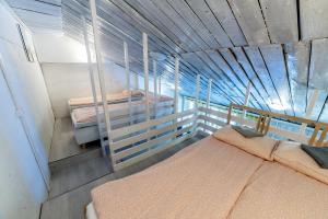a room with two beds in a room with a ceiling at Апарт-коттедж Princess mini in Vyborg