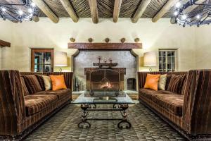 a living room with two couches and a fireplace at Westward Look Wyndham Grand Resort & Spa in Tucson